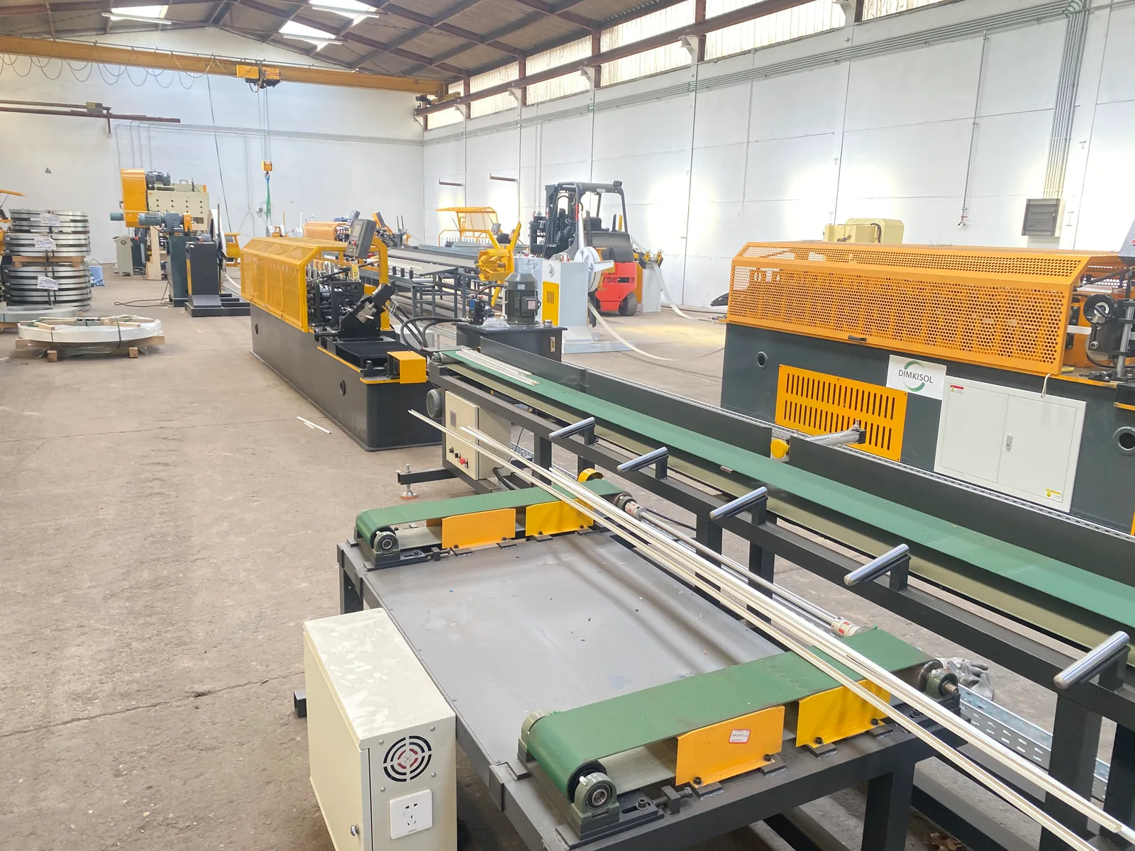 Decoiler and forming stations being aligned during on-site commissioning in Belgium